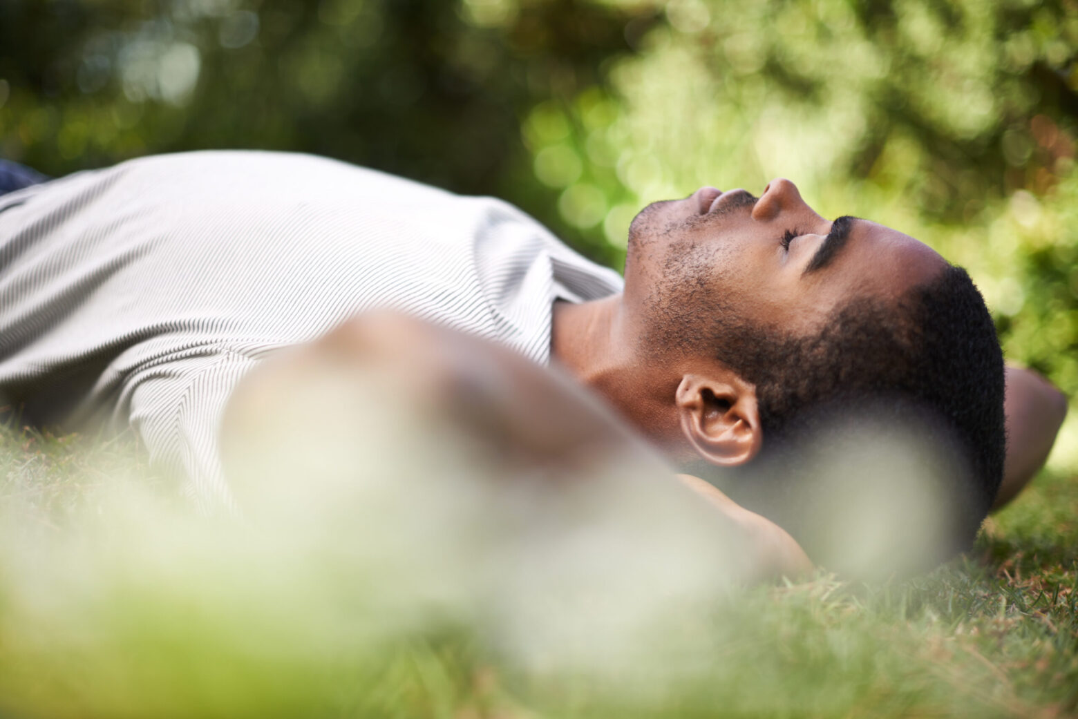 Catching a nap outdoors. Cropped shot of a handsome young man lying on the grass outdoors