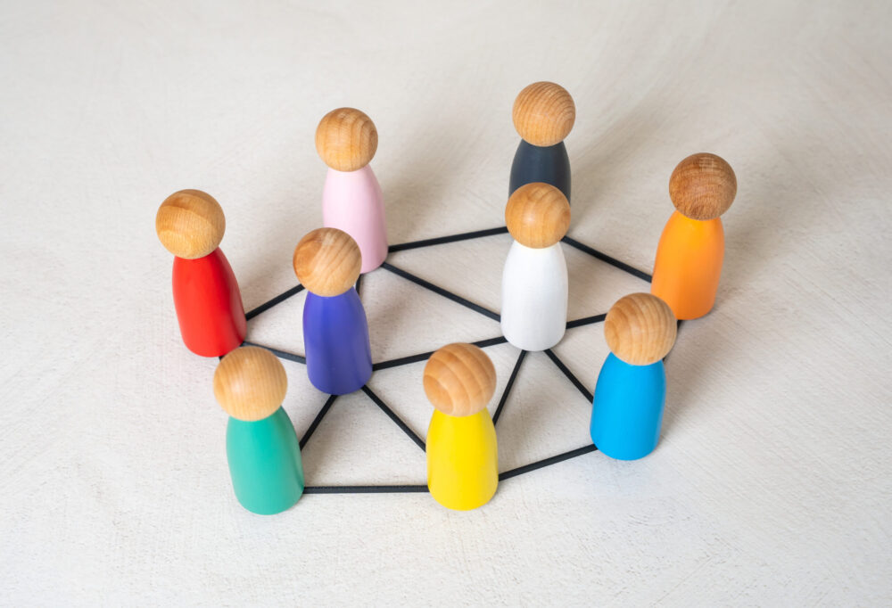 Multicolored figures of people are connected by lines. Multiculturalism, cooperation. Cultures and nations work together. Connection between countries. Diversity, international teamwork